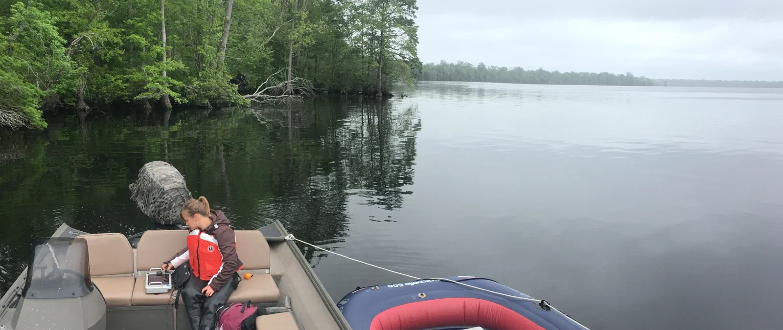 Archive photograph of a researcher collecting radar data on Lake Drummond