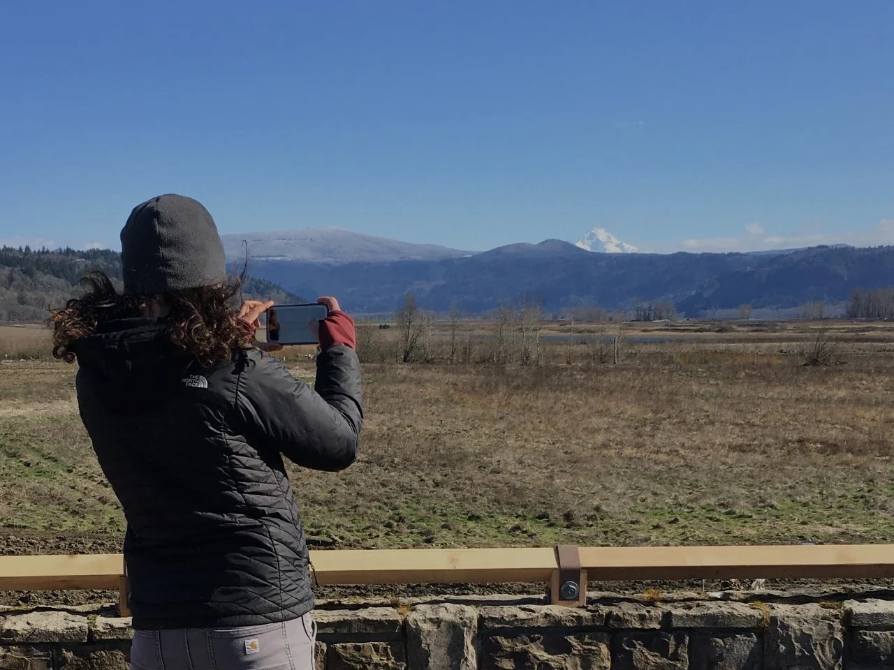 Archive visitor taking a photograph at a Steigerwald overlook in Washington
