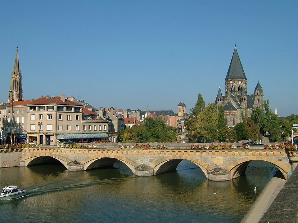 Low arches of Moyen-Pont, Moselle water and city buildings beyond;16October2005.