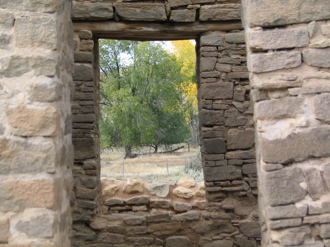 Archival view through a central doorway in the masonry at Aztec Ruins