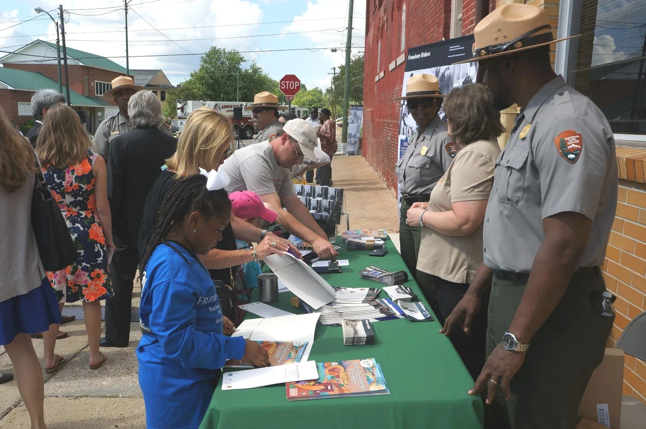 Brochure and passport-stamp table at an Anniston commemoration, NPS archive