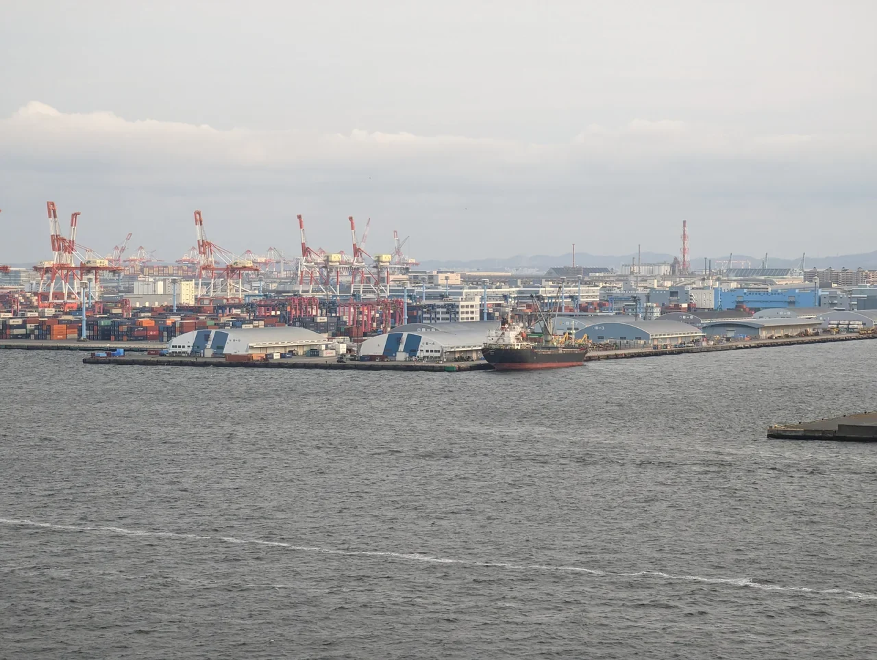 Cranes and warehouses at Yokohama container port seen from Skywalk