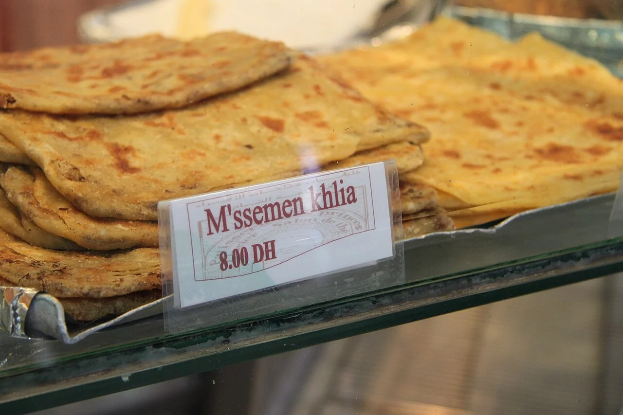 Pastry display labelled msemen khlia in Marrakech, April 2012; its visible 2012 price label is not a current price.