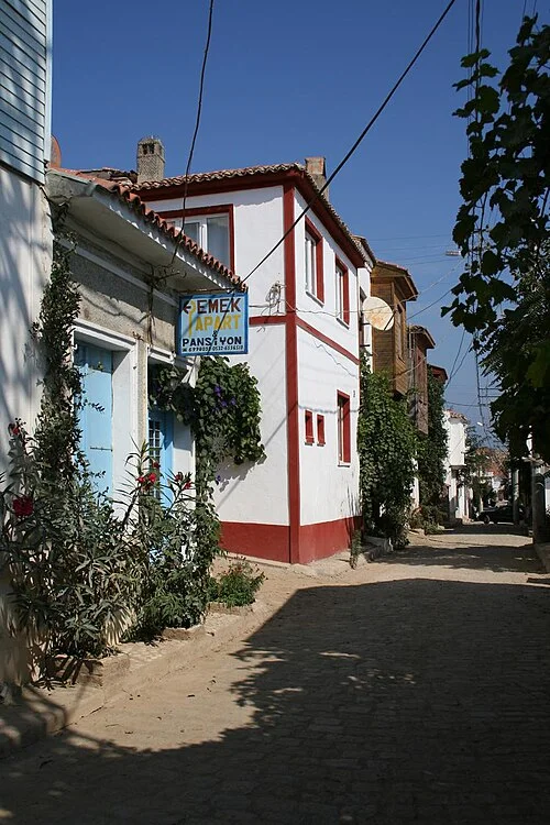 Narrow street and house frontages in central Bozcaada; September 2006 archive photograph.