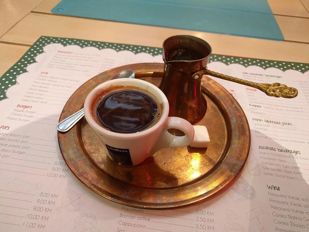 Coffee pot, cup and tray in Sarajevo, March 2017; printed menu behind is historical, not current pricing.
