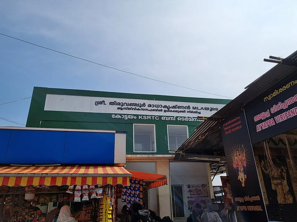 Kottayam KSRTC otobüs terminalinin tabela ve dükkân görülen giriş çevresi