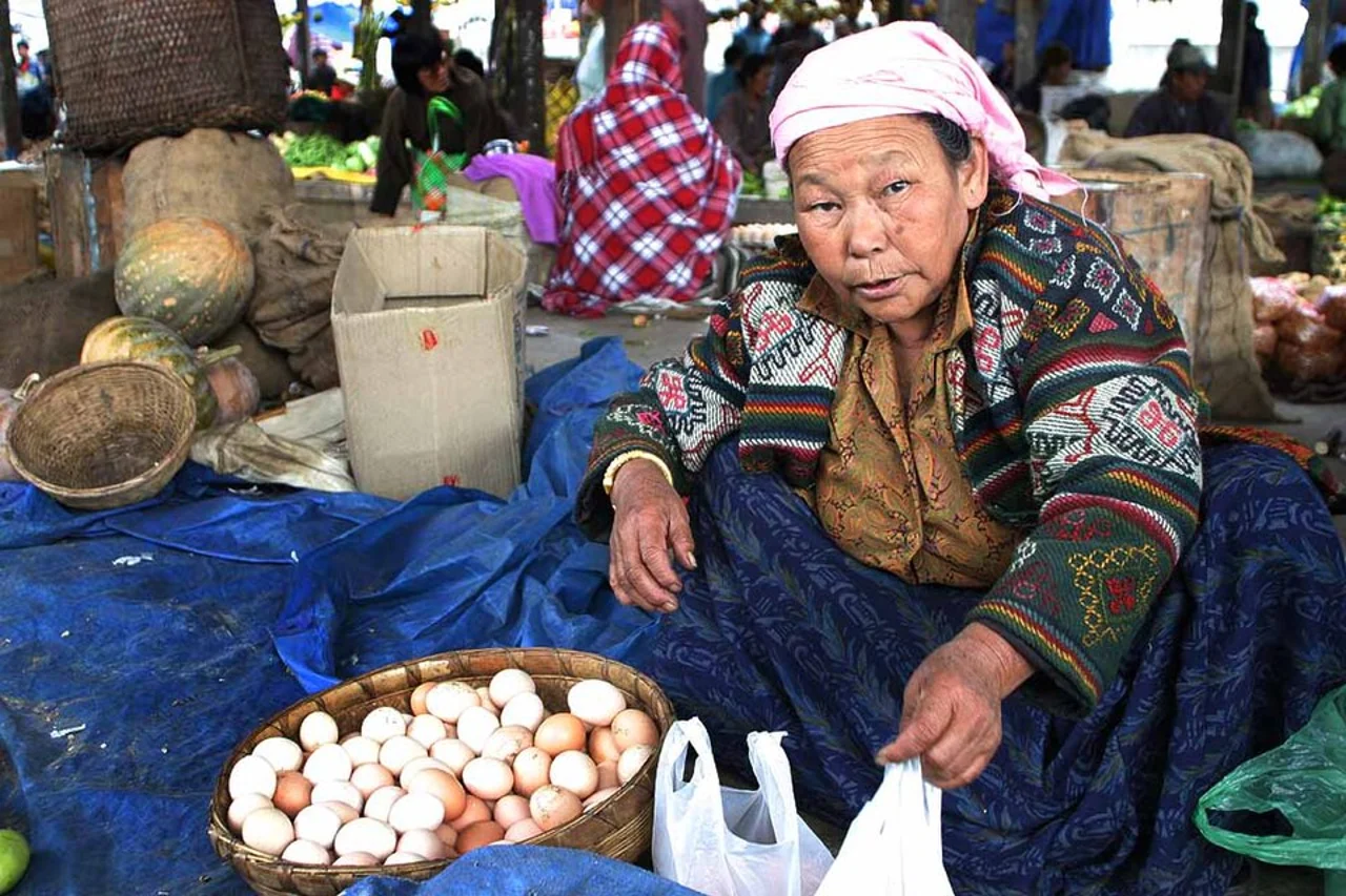 Vendor and produce at Thimphu market; Steve Evans, 20 October 2006, historical market scene