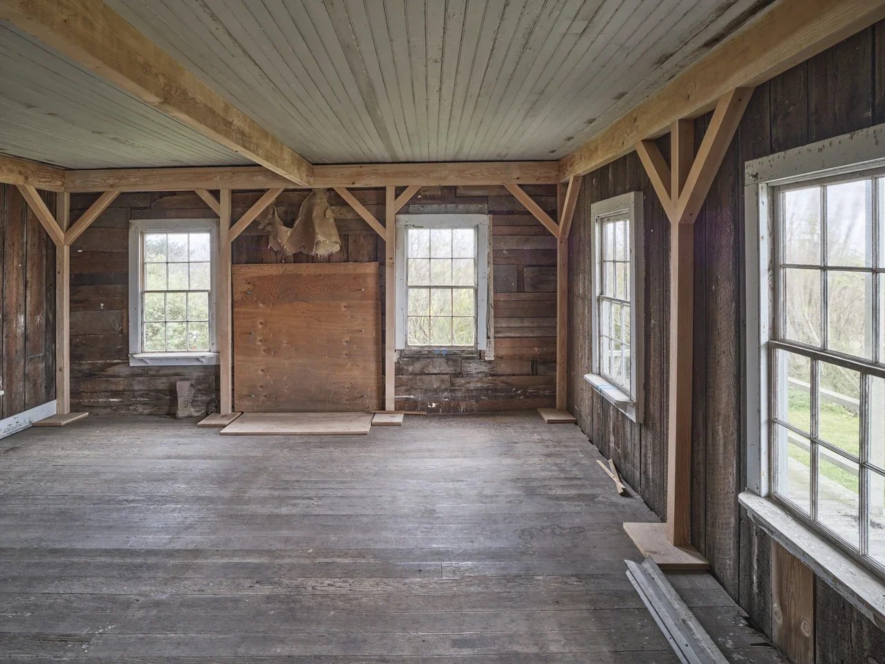 Wooden braces and windows in the Ferry House living room, closed-interior archive