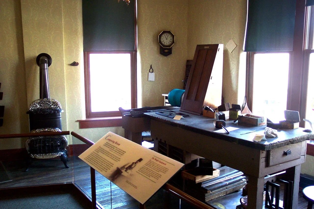 Archival interior of the Wright brothers historic print shop with desk and stove