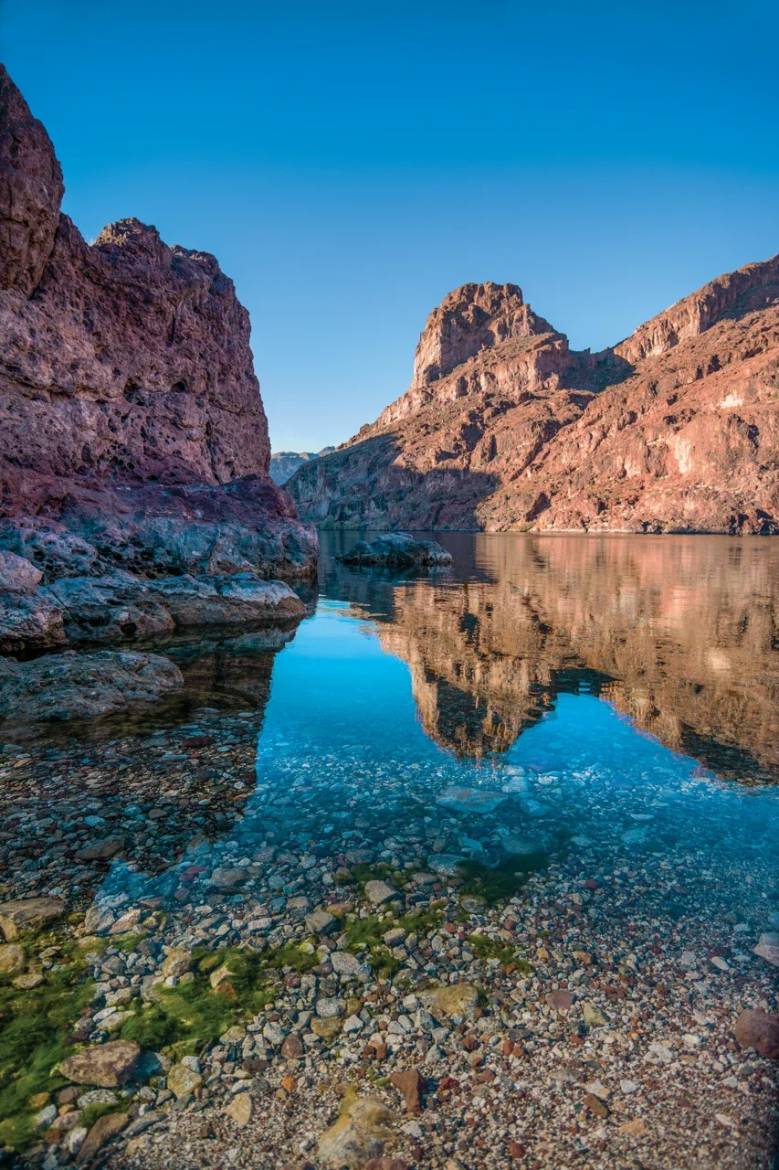 Cliffs reflected in Black Canyon water, NPS archive