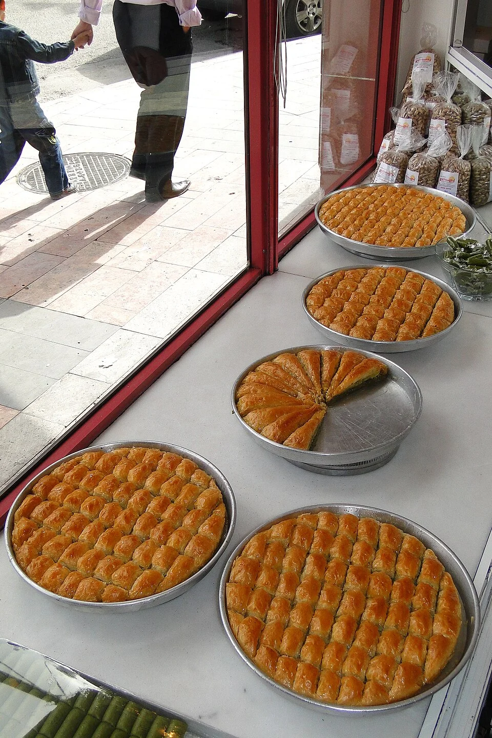 Baklava trays and selling context in Gaziantep, May 2011; not present stock or a claim that the same business operates today; people appear in city context.