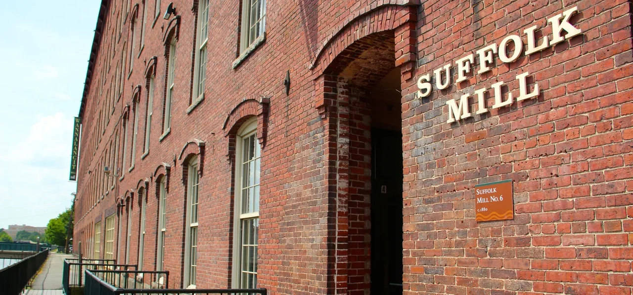 NPS archive exterior of Suffolk Mill, Lowell; not evidence of current canal access