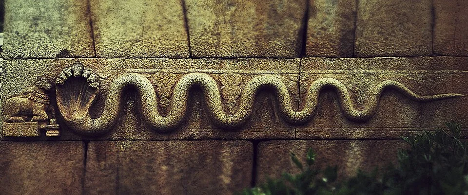Ancient carved stone serpent detail at a Chitradurga Fort entrance