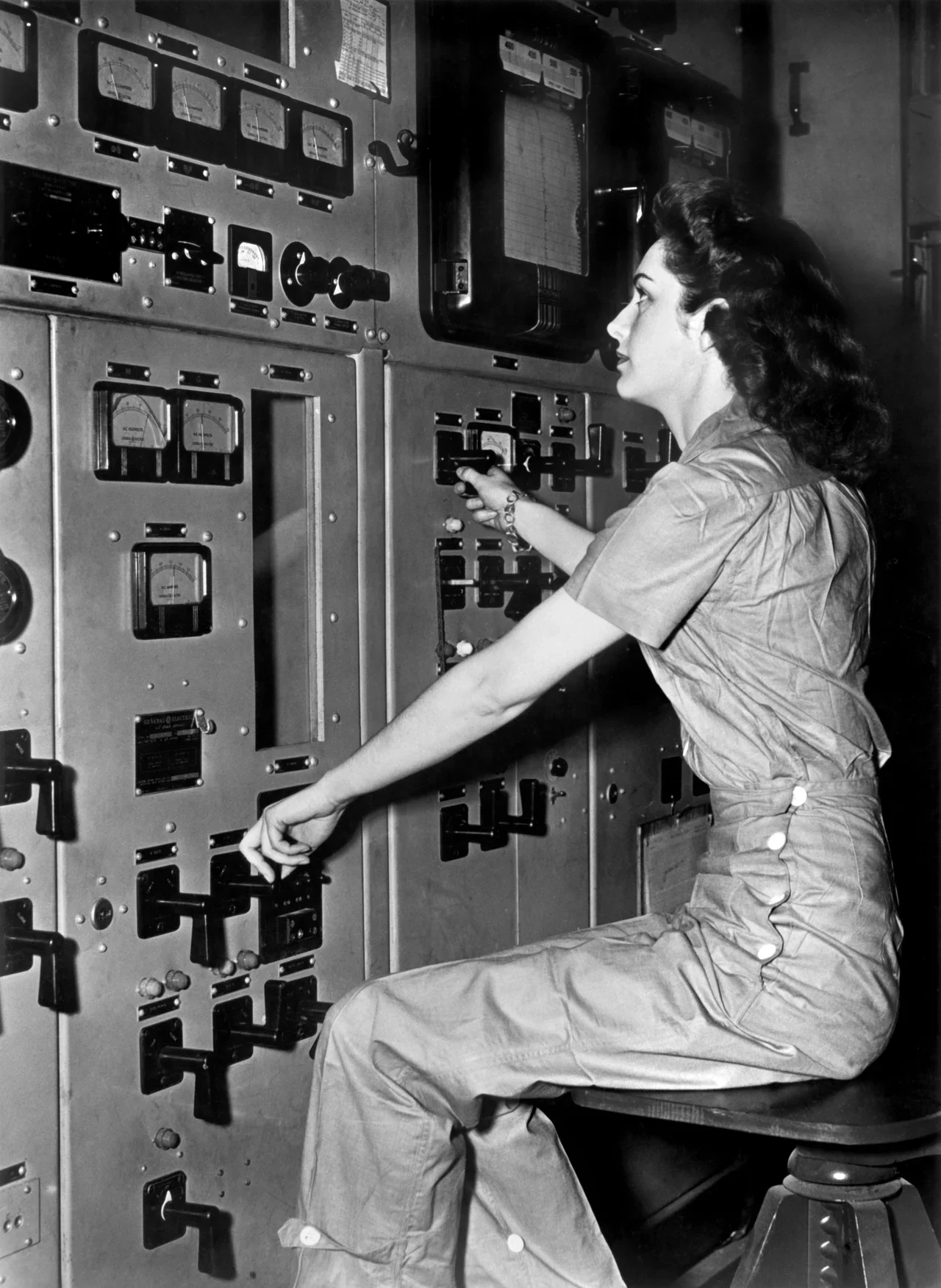 Calutron operator at an instrument panel, historical archive