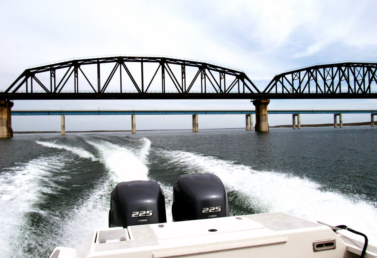 Highway 90 and railway bridges over Amistad, archive view from a boat