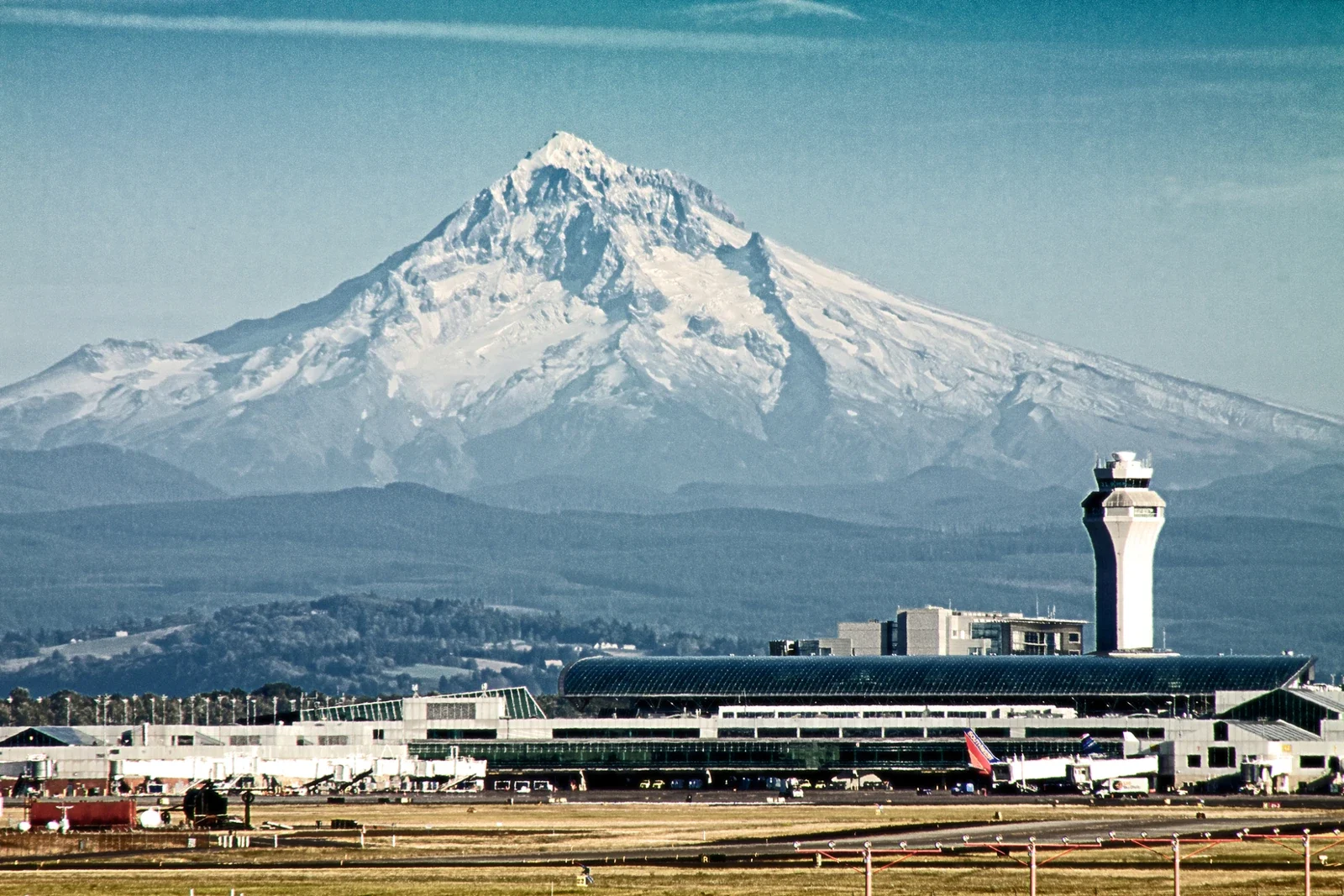 Mount Hood beyond Portland airport terminal and control tower, archive