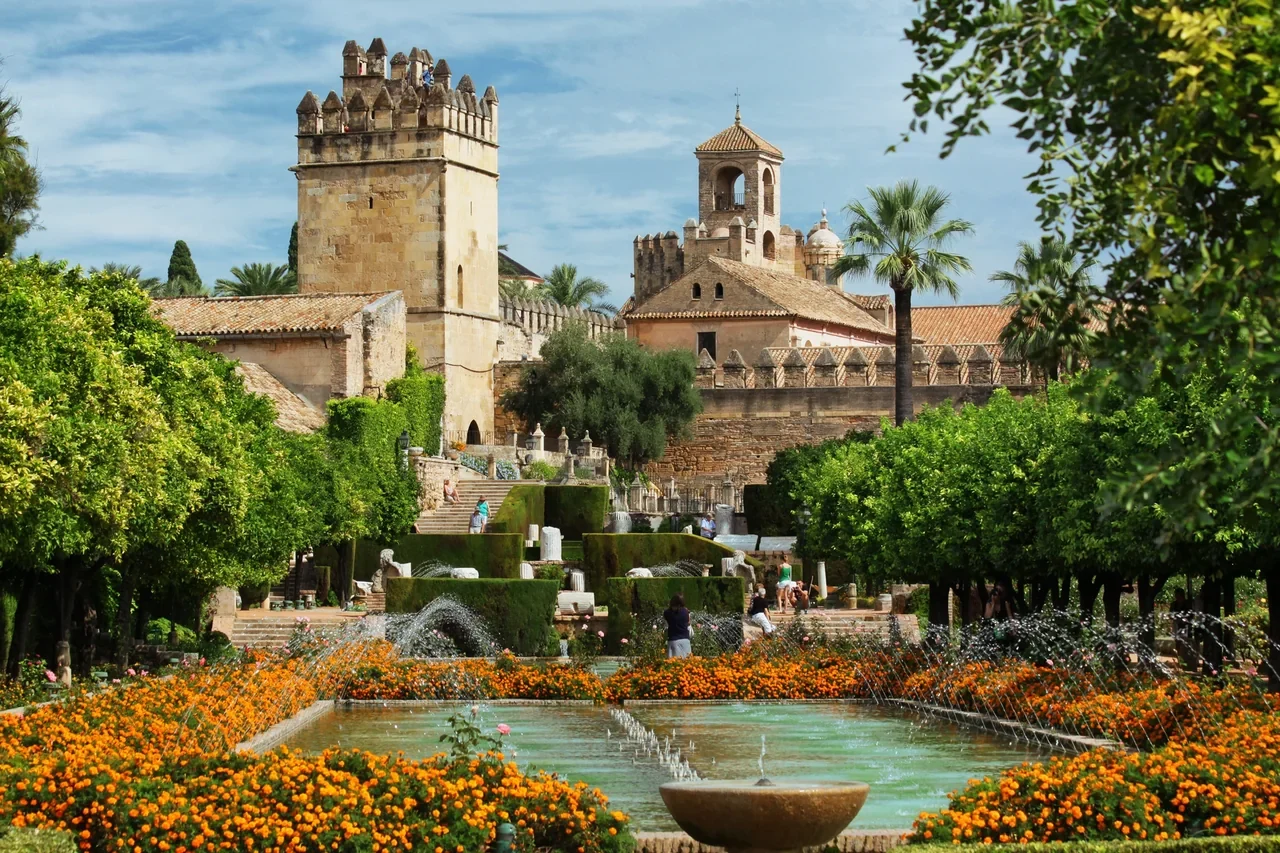 Alcázar gardens in Córdoba with fountains and towers behind, July 2018 archive