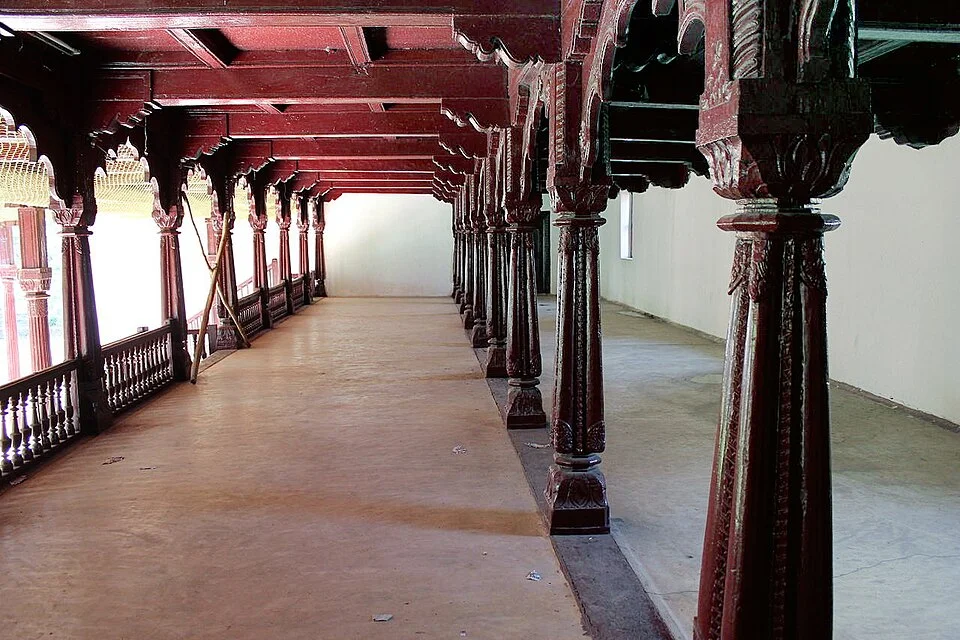 Distinct interior wooden-column scene at the Shivamogga palace