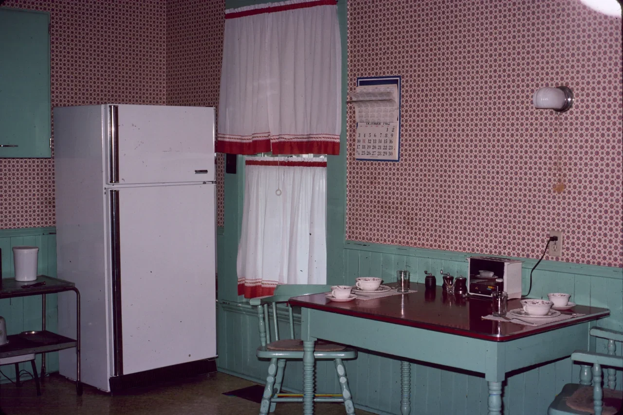 Archival interior of the historic Truman Home kitchen with table and cupboards