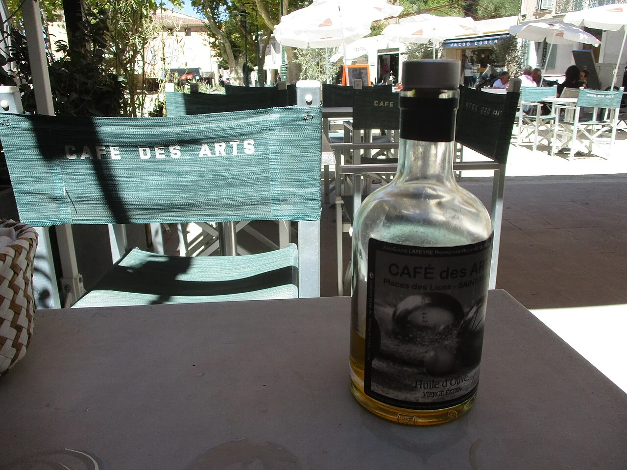Olive-oil bottle on a Café des Arts table near Place des Lices, Saint-Tropez; August 2020.