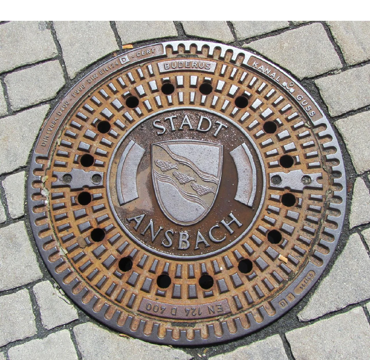 Close-up of a manhole cover in Ansbach street fabric, 2011