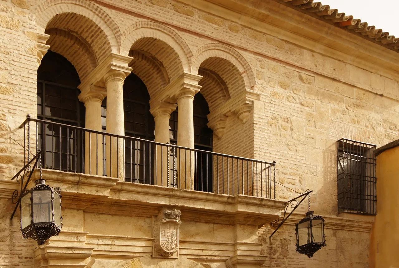 Arched balcony and coat of arms above the Royal Stables entrance in Córdoba, August 2010