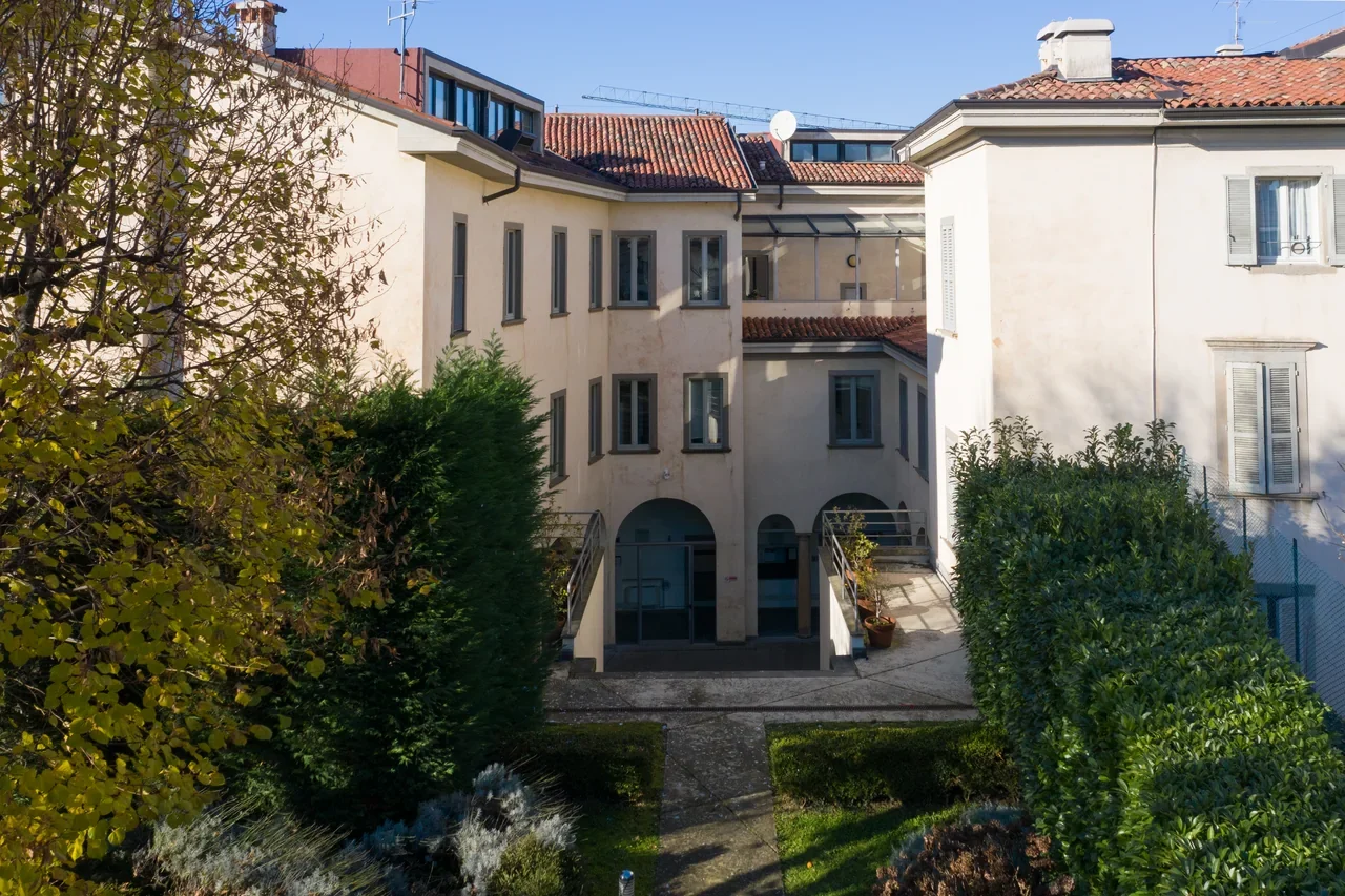 Garden-facing facade of the University of Bergamo Rosate building, 2025