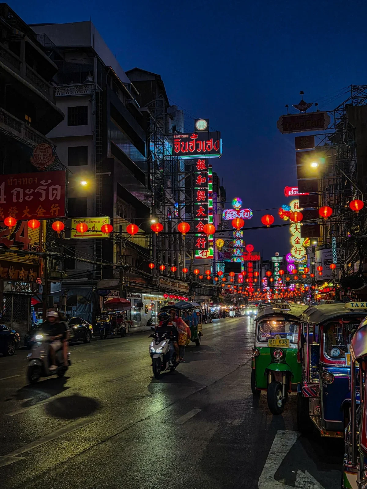 Illuminated signs and night street life in Bangkok Chinatown; Jessica Sacco.