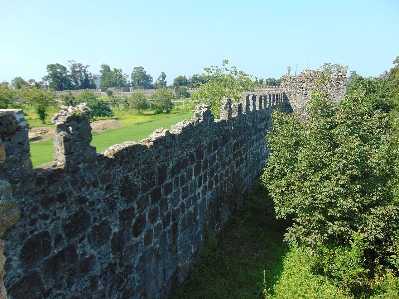 Stone walls and green interior grounds of Gonio Fortress south of Batumi; August 2017.