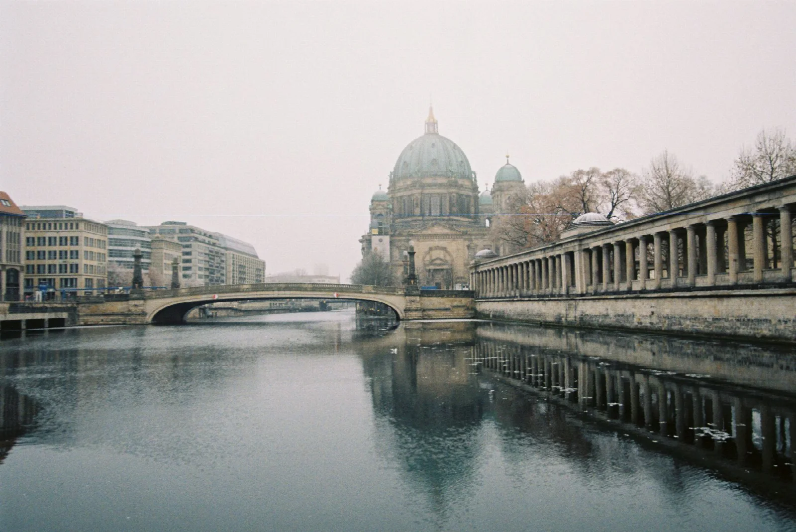 Berlin Cathedral, the Spree River and a historic bridge in misty weather