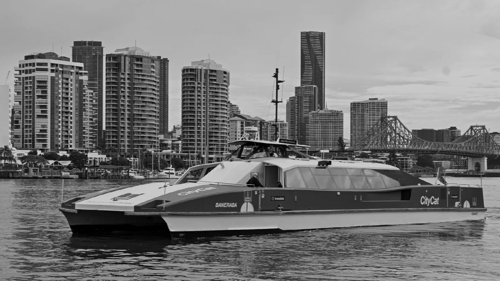 A black-and-white view of a CityCat ferry on the Brisbane River