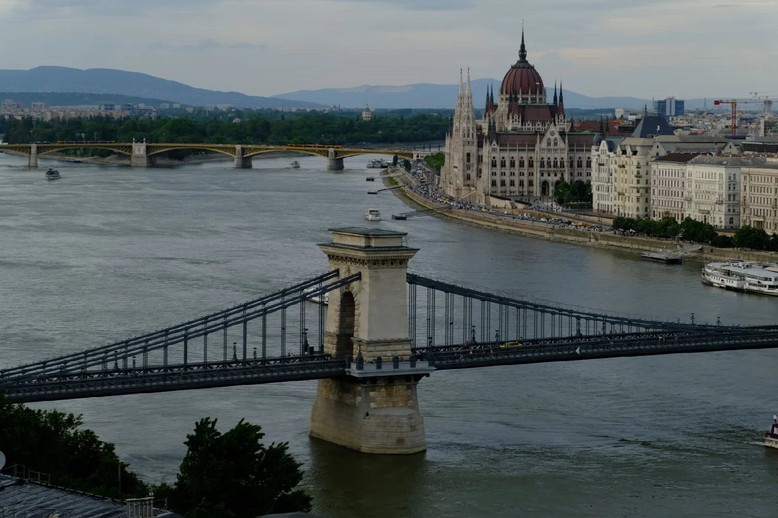 An elevated view of Budapest’s Danube River, Chain Bridge and Parliament