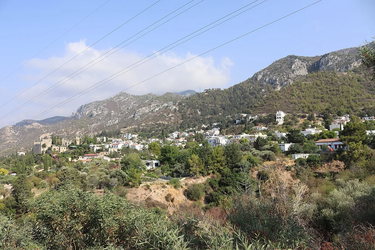Bellapais köyü ve manastırının yoldan uzak görünümü; Ağustos 2022.