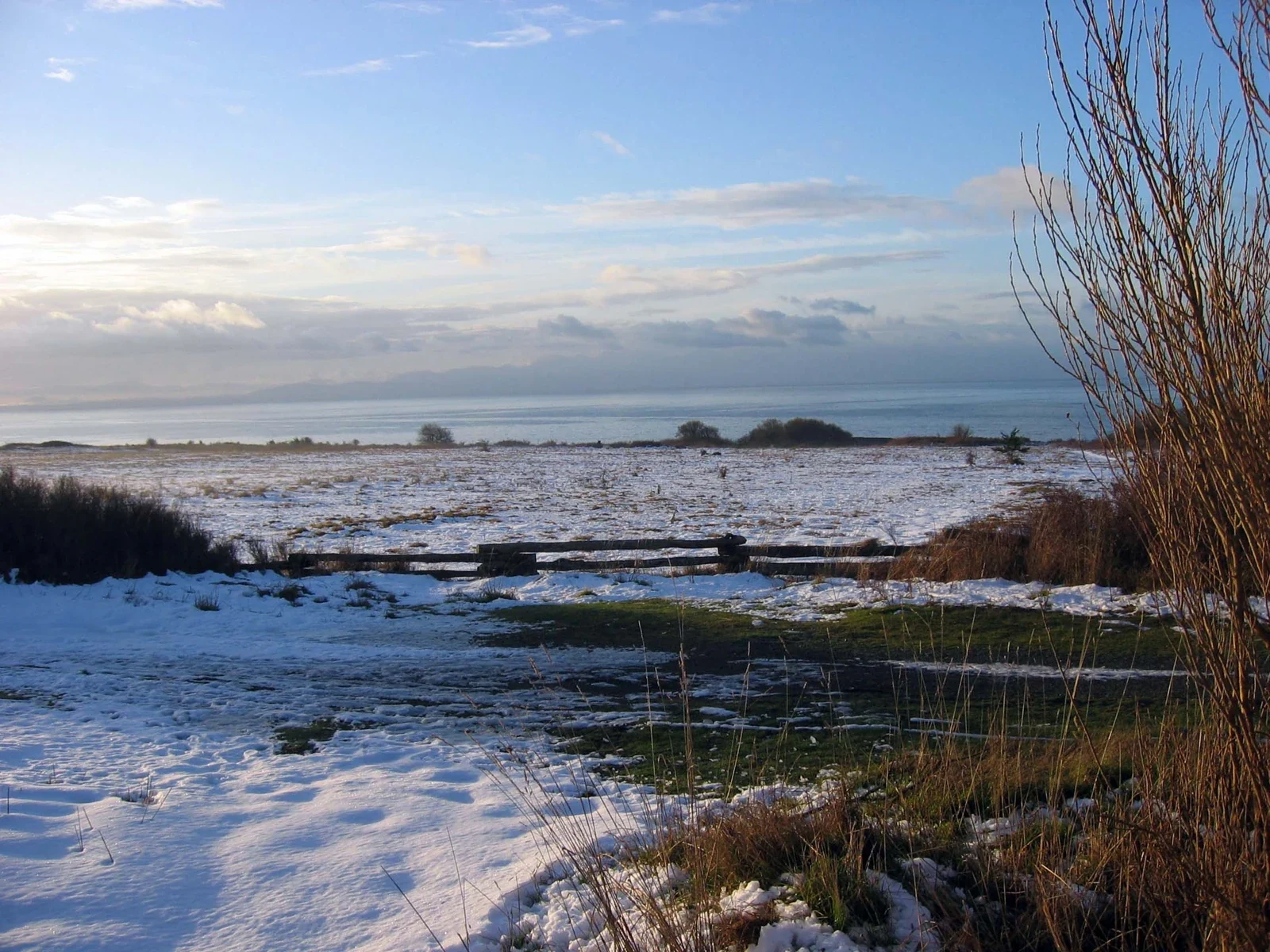 Snow on American Camp prairie and sea horizon, San Juan Island winter archive