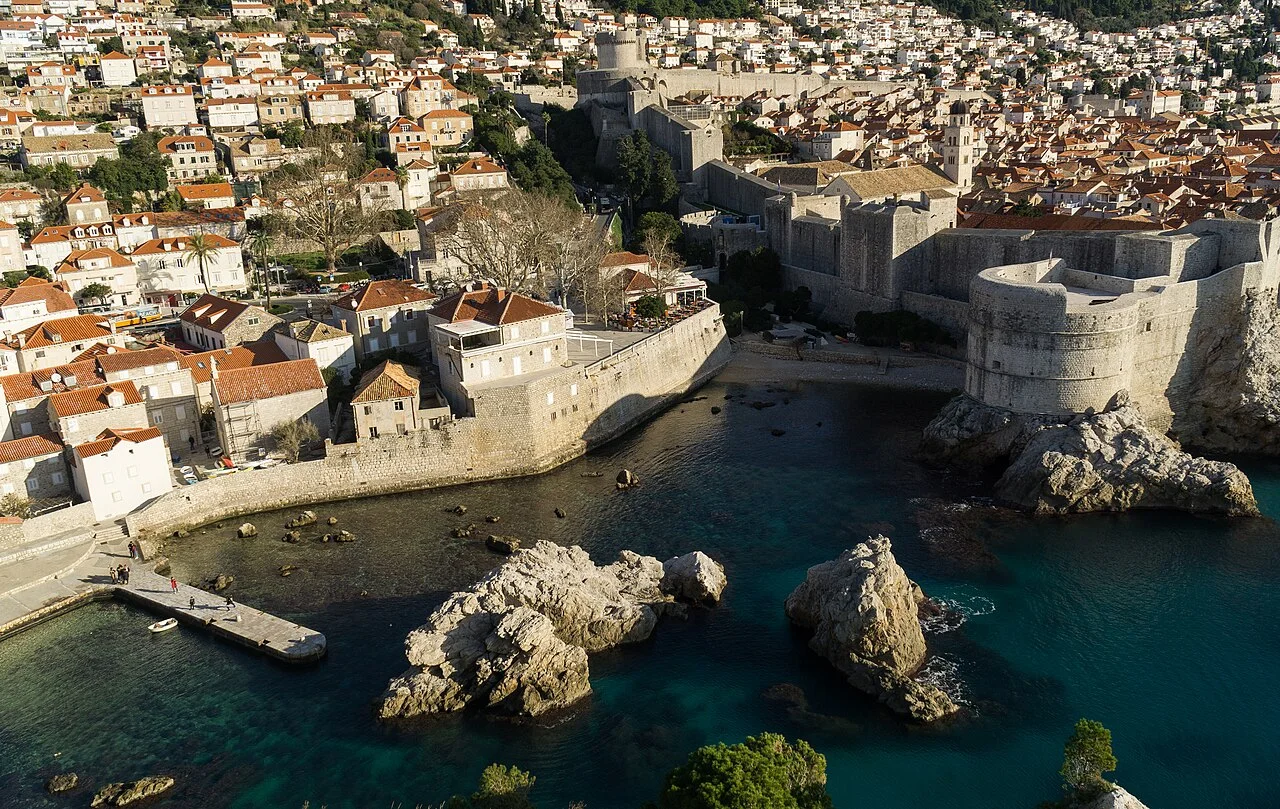 Dubrovnik city walls, shoreline and historic roofs seen from Lovrijenac; December 2019 archive photograph.