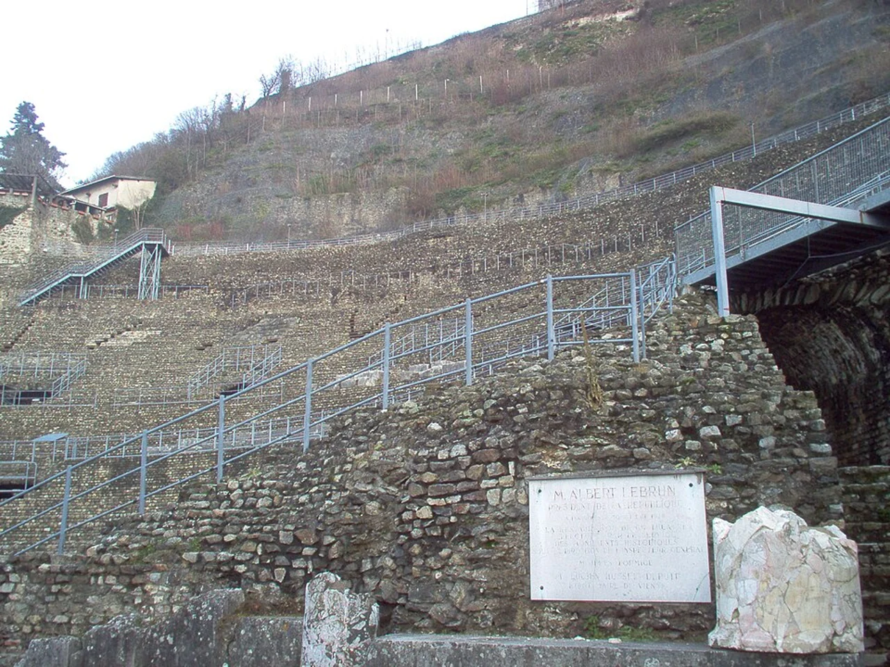 Stone tiers and historical inauguration plaque at Vienne ancient theatre; captured 2010-01-23, not evidence of present conditions.