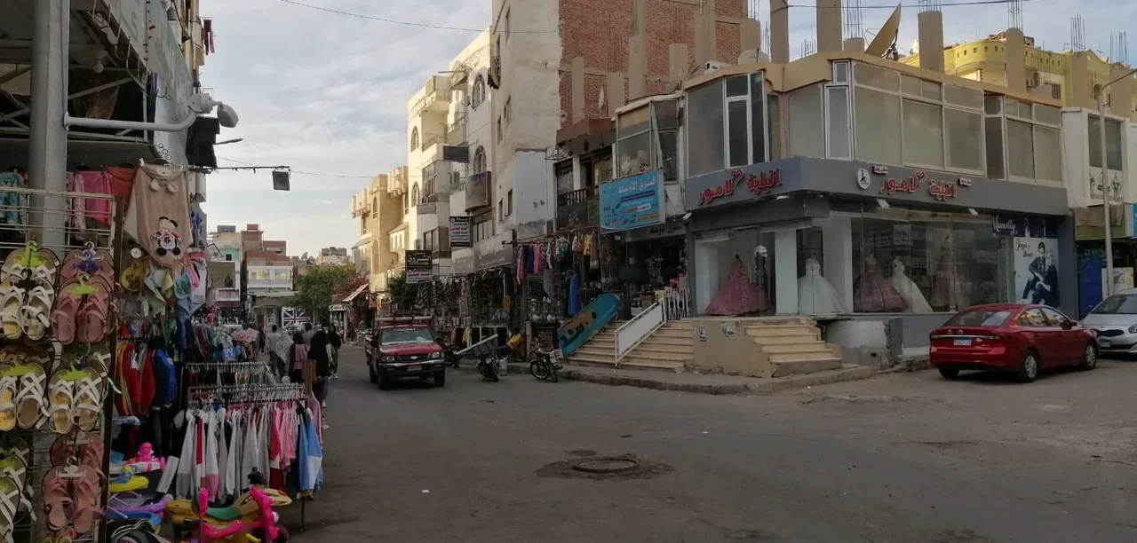 Shops and vehicles at an old-town junction in Hurghada