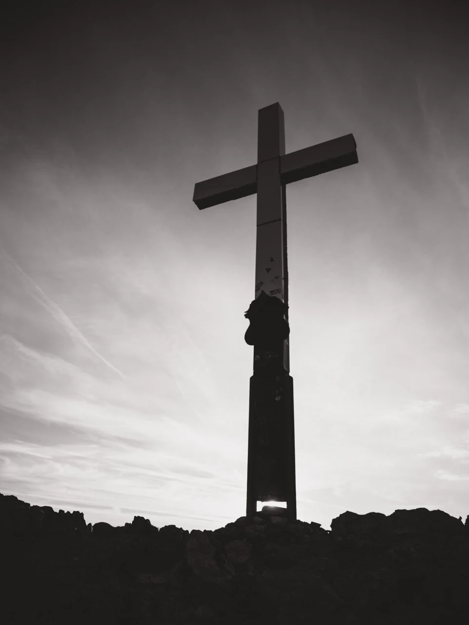 A summit cross and human silhouettes around Garmisch-Partenkirchen