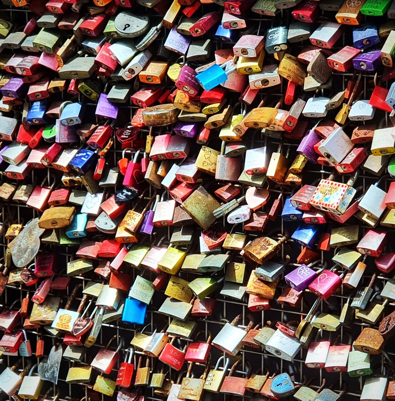 Colourful padlocks on a metal railing in Heilbronn
