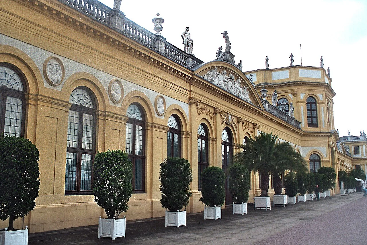 Yellow facade and walkway of the Orangery in Kassel, photographed in July 2007.