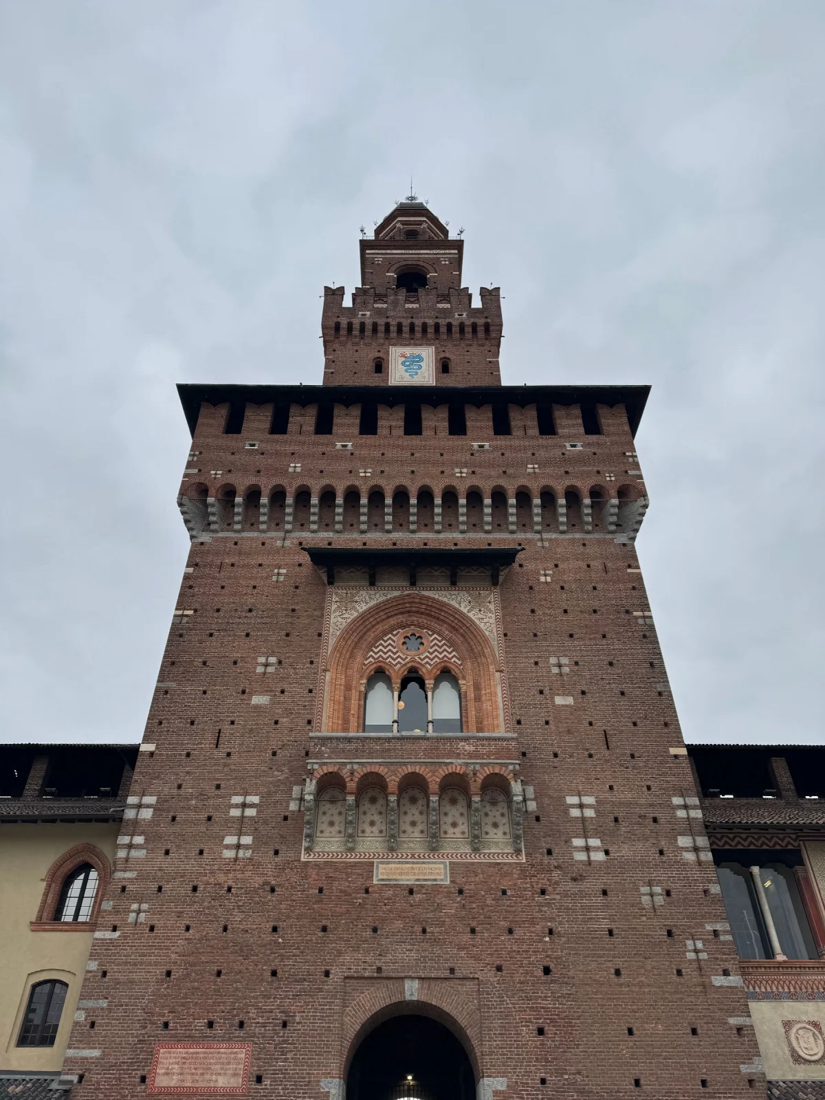 Brick walls and the central tower of Sforza Castle in Milan