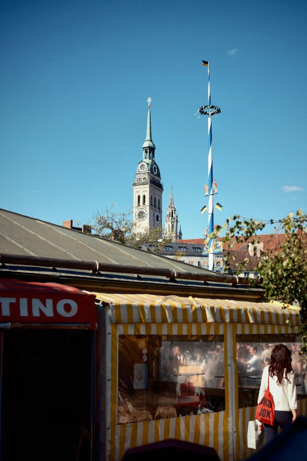 Market stalls and a church tower around Munich Viktualienmarkt