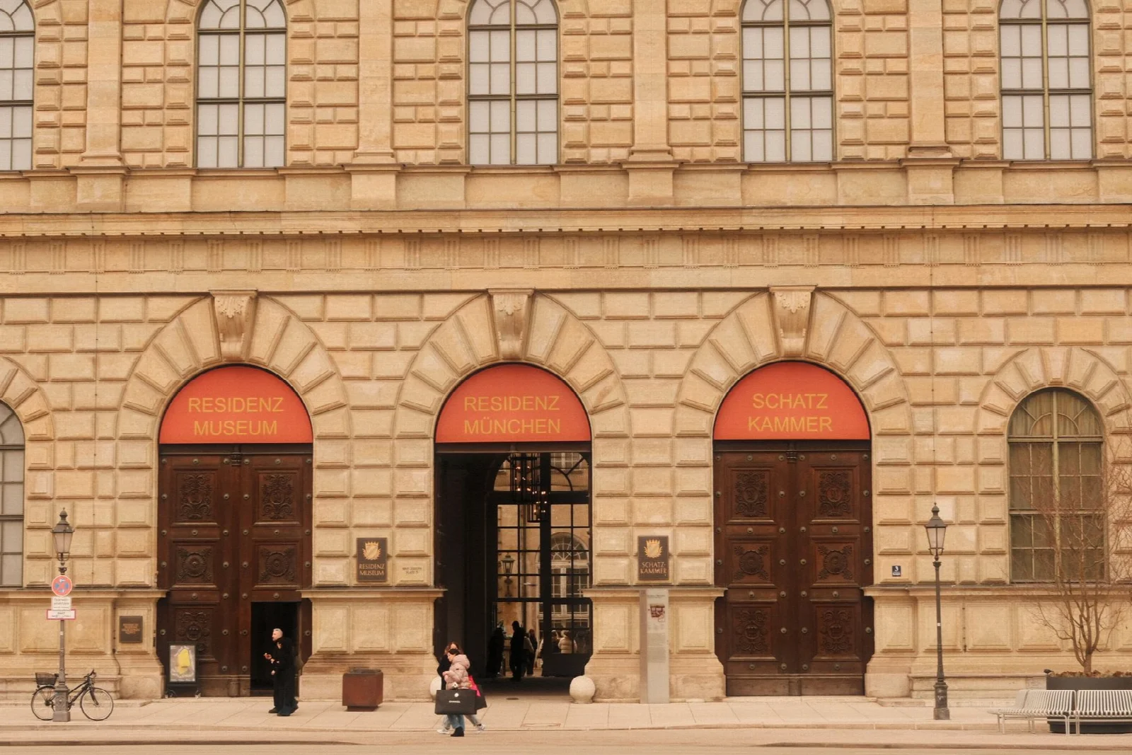 The historic stone facade and street outside Munich Residenz Museum entrance