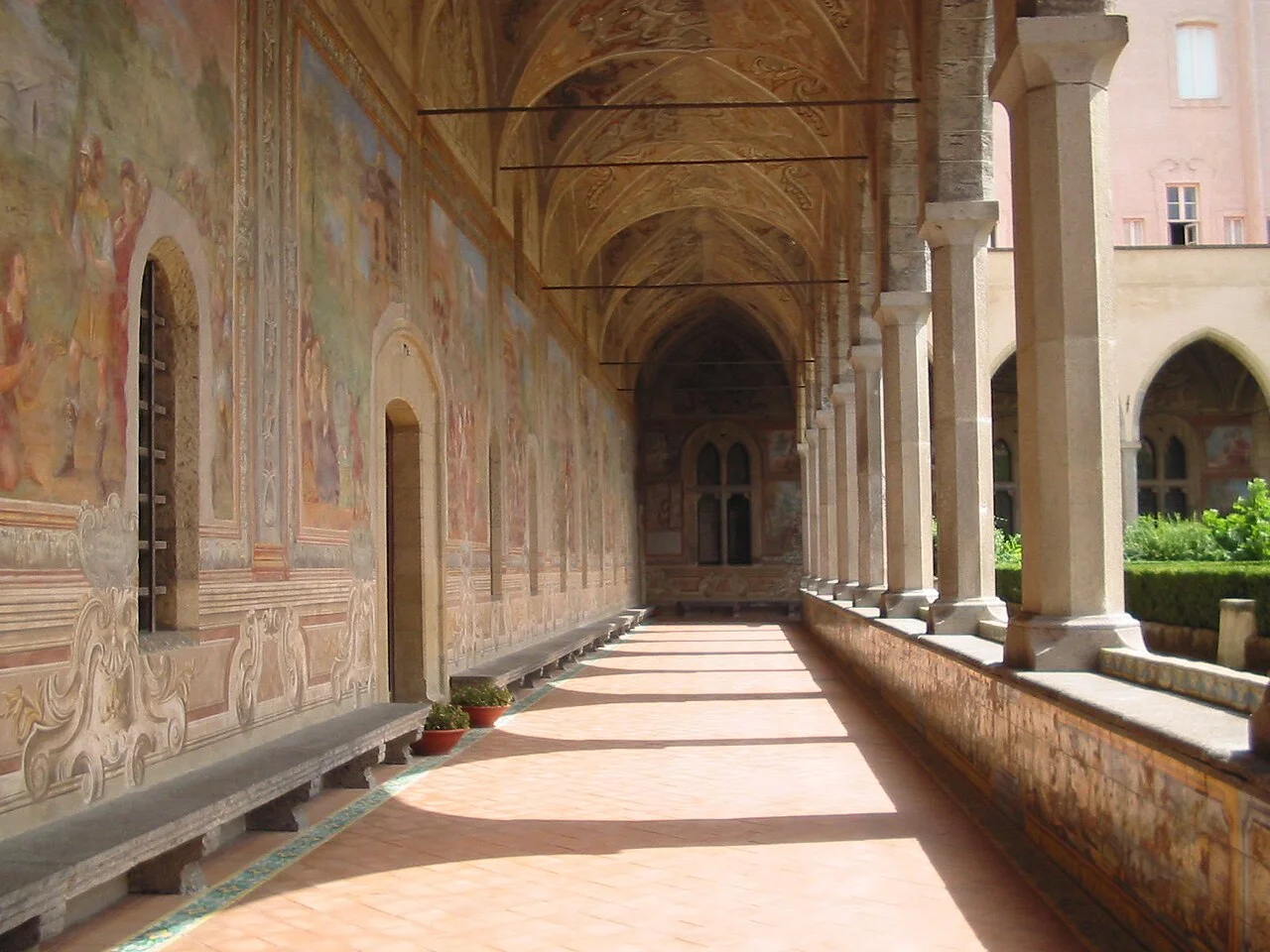 Frescoed cloister corridor at the Santa Chiara complex in Naples; August 2005 archive photograph.