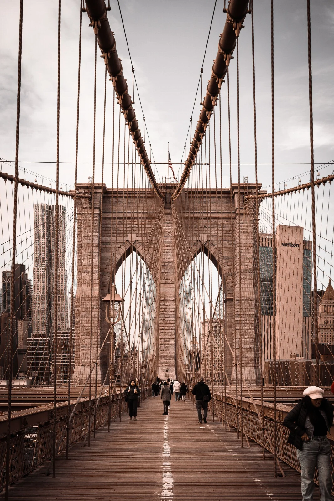 Stone towers and steel cables along the pedestrian walkway of Brooklyn Bridge, New York
