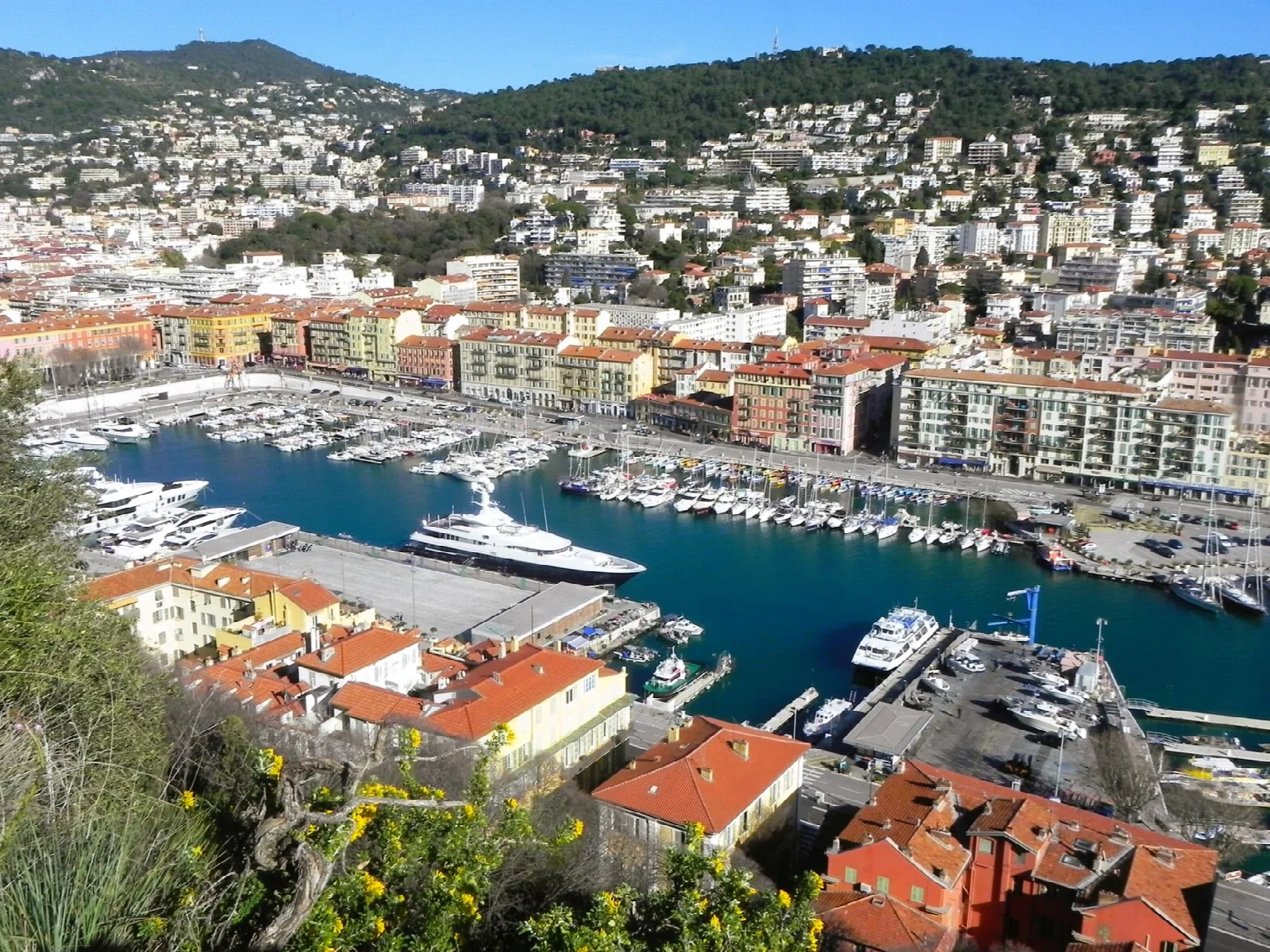 Colourful city buildings and boats around Nice harbour