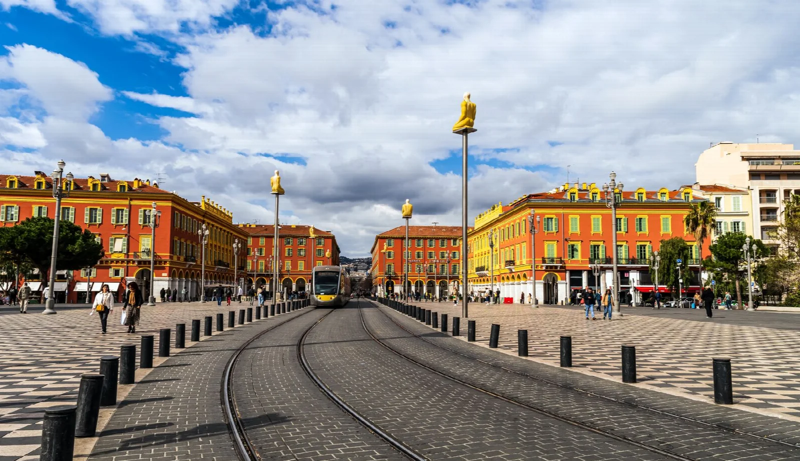 Colourful facades and a tram at Place Masséna in Nice