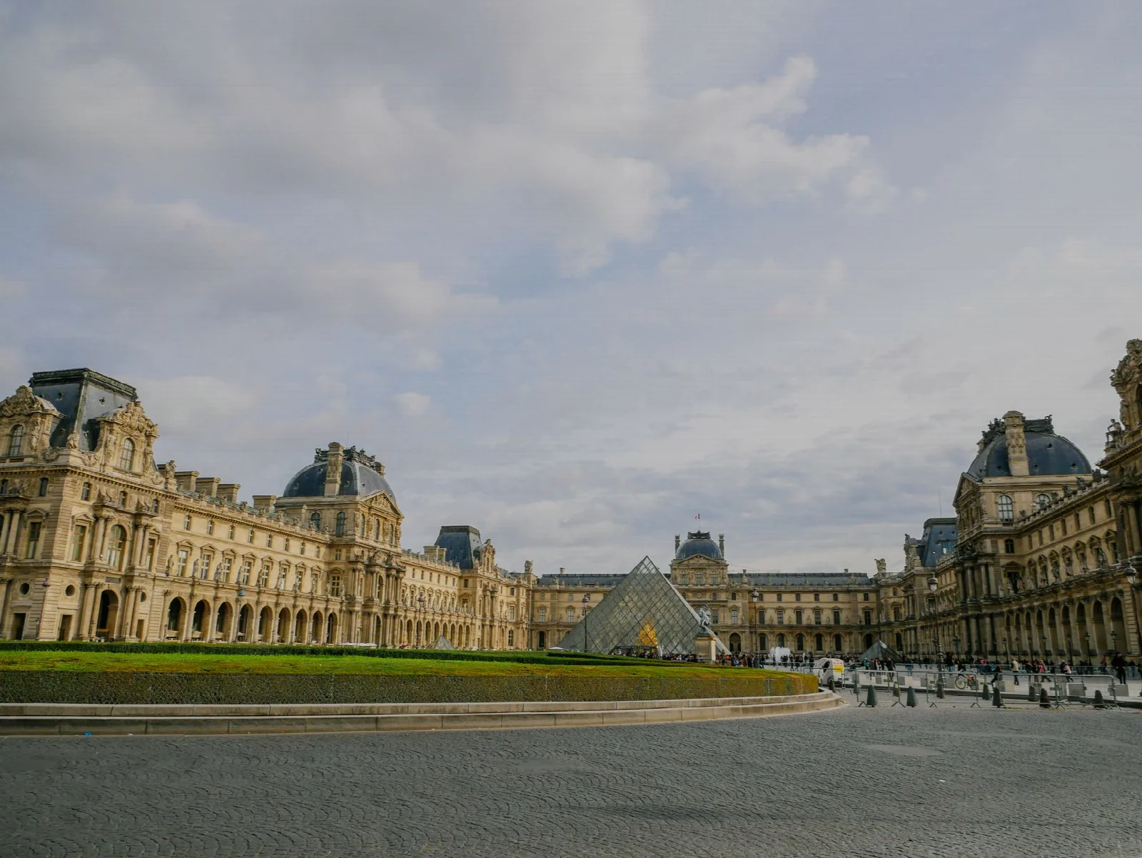 The historic facade of the Louvre Museum and its glass pyramid in Paris