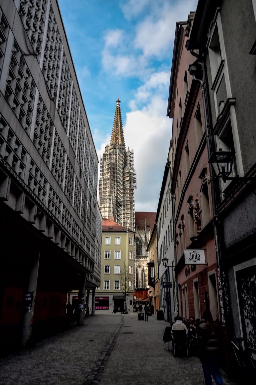 One cathedral tower seen from a Regensburg street.