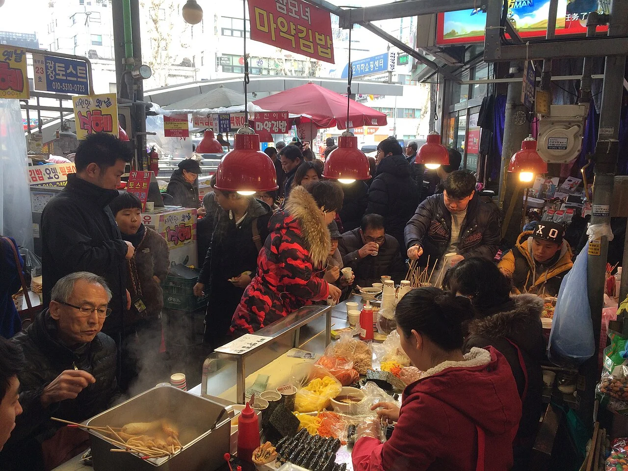 Mayak-gimbap preparation and customers at Gwangjang Market, Seoul, 2 January 2016; not a current business menu.